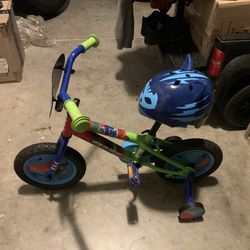 Toddler bike with training wheels and a helmet