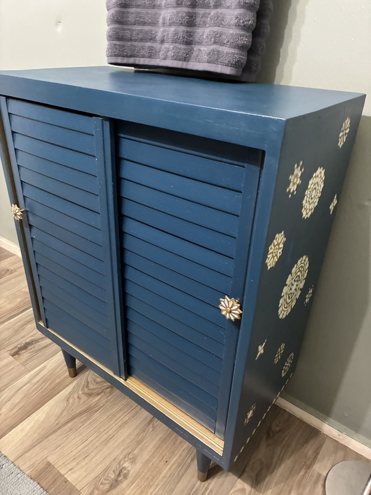 Hand painted Shutter Door Storage Cabinet With Floral Decor Painted In Pearl White And Metallic Gold