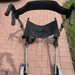 Easy-glide walker with hand brakes and built-in seat $60