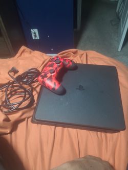 Playstation 4 with camouflage red controller