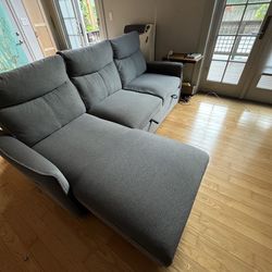 Gray sleeper fabric L-shaped sofa with a chaise lounge and storage