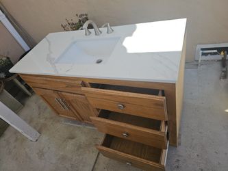 BATHROPM SINK AND OAK CABINIT, WITH MOEN FAUCETS.