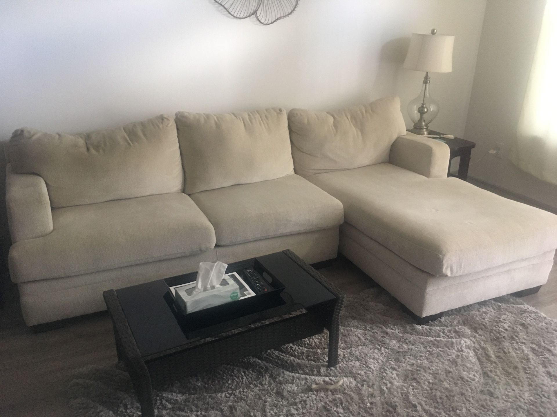 Cream couch and black tv stand