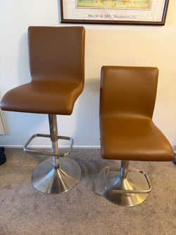 Two brown leather barstools