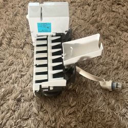 This is a GE Refrigerator Ice Maker, model WR30X28682.  