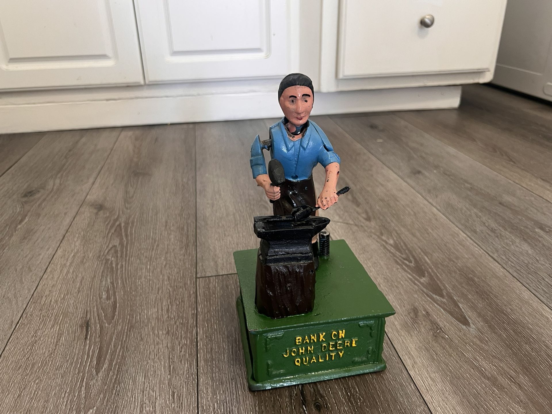 Vintage Bank on John Deere Quality cast iron mechanical blacksmith w/ anvil coin bank