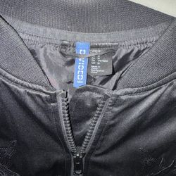 This H&M black satin Sukajan jacket features an intricate tonal dragon embroidery and a map design on the back. 