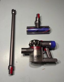 Dyson V8 vacuum with all the attachments and charger and an extra battery