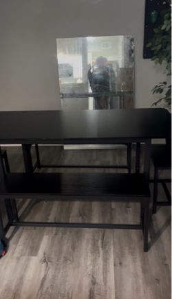 Black table with 2 benches and 2 stools
