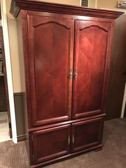 Vaughn Bassett Entertainment Center / Armoire in Cherry finish. 42” W x 22” D x 74” H
