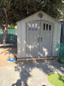 Storage shed with wooden base