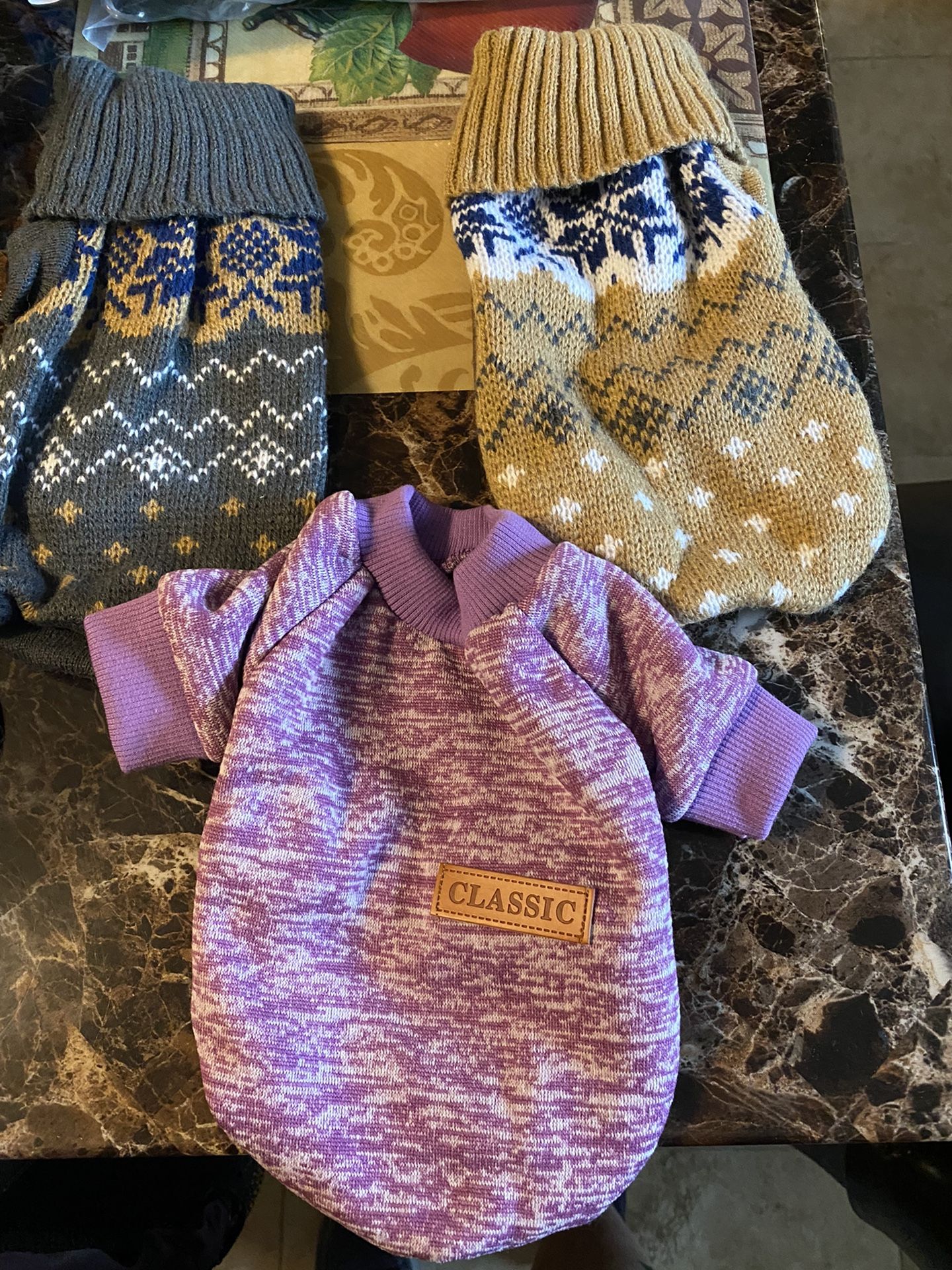 Three small sweaters for dogs