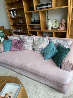 mauve corduroy-style deep sit sofa and matching love seat with pillows