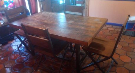 Table with 4 chairs and bench. Sits 6 people