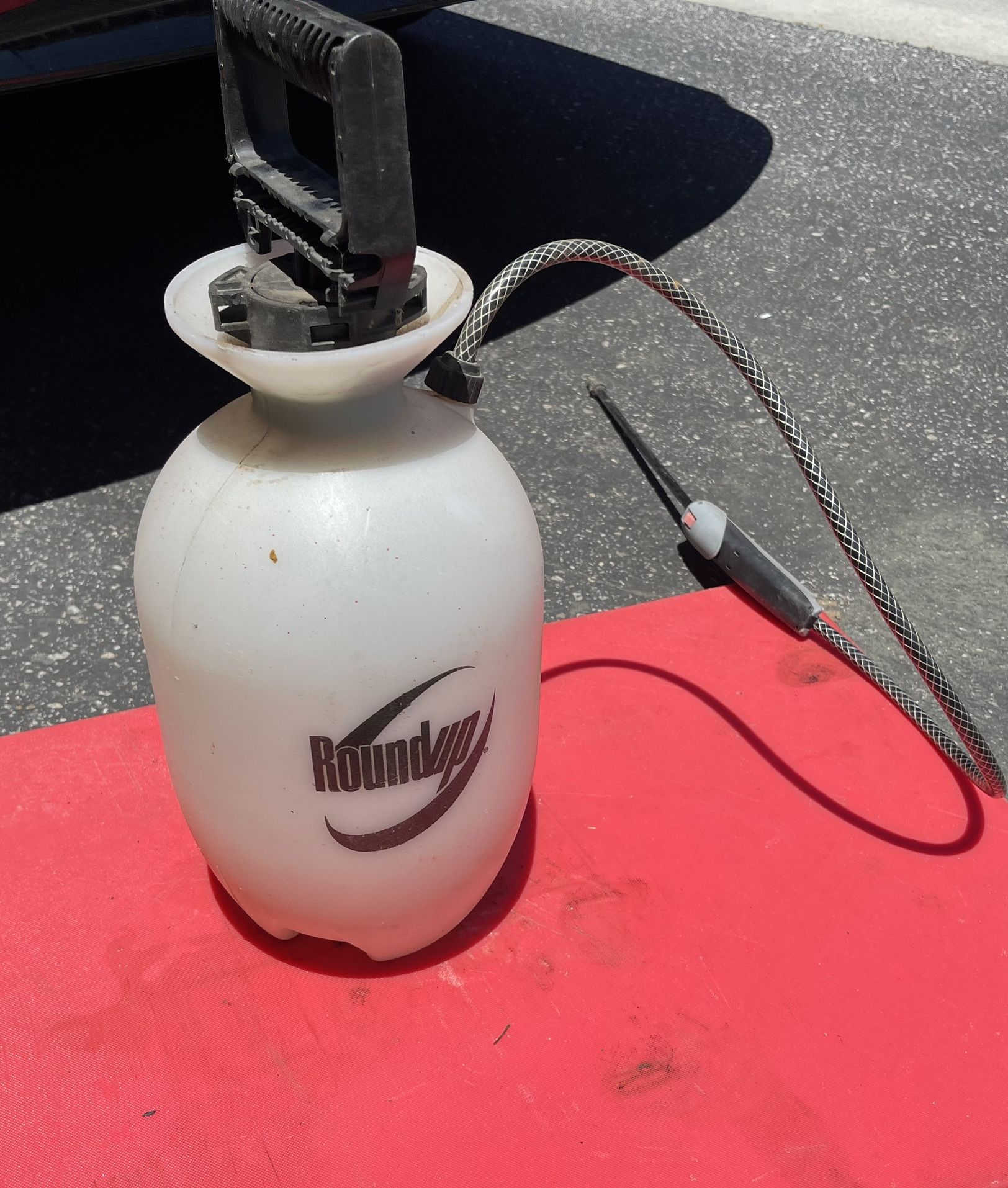 a Roundup 1-Gallon plastic pump sprayer,