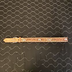 Vintage Western-style leather belt featuring a hand-tooled and painted design of horses and a Native American figure.