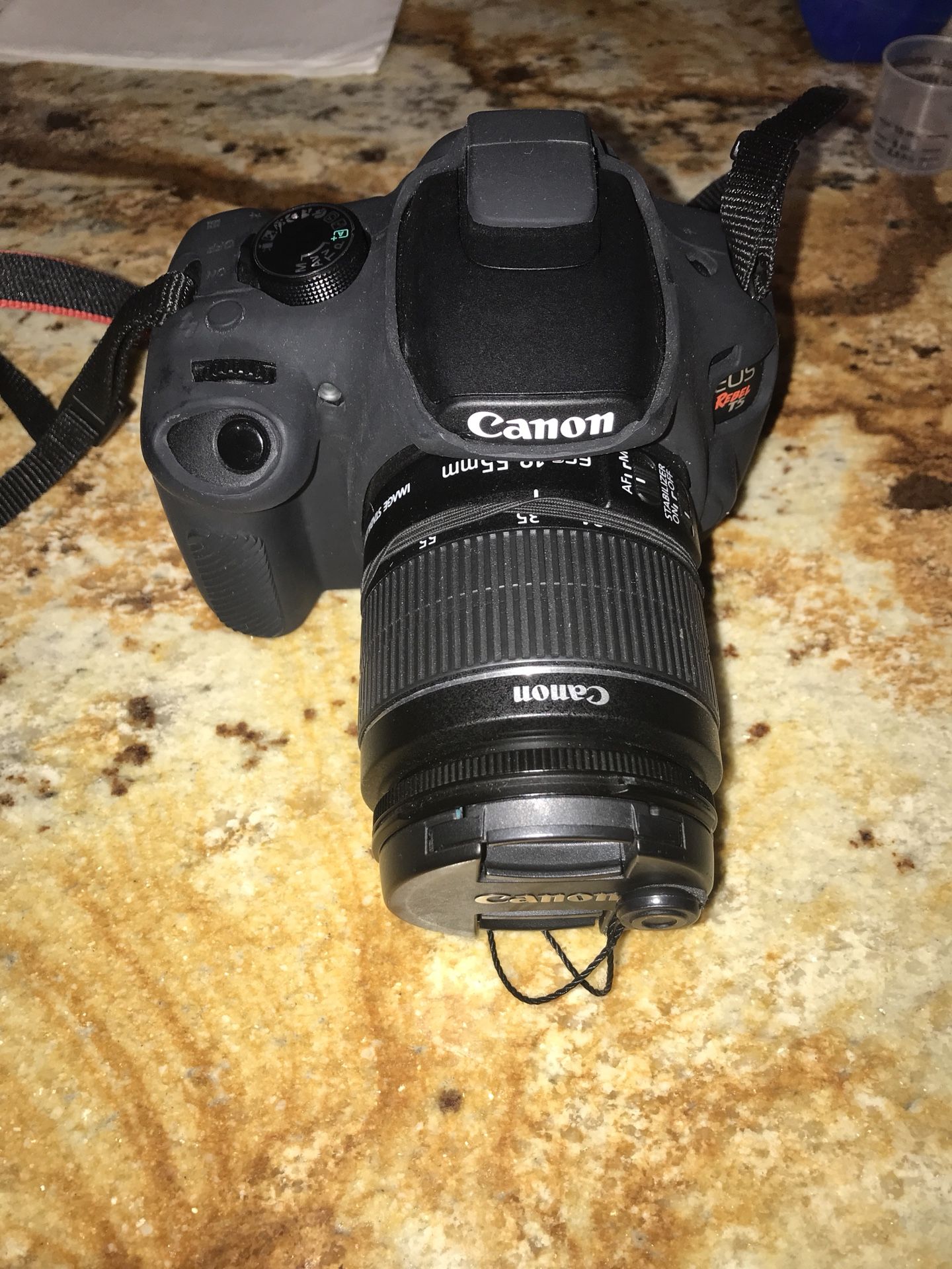 Canon Rebel T5, it comes with 2 lenses for different ranges of photos, 2 batteries and chargers, a case for the camera which is on, a thing to make t