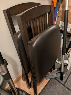 Folding wooden chairs with cushion.