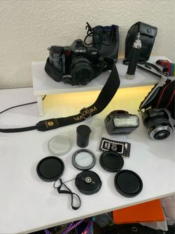 complete vintage Minolta 35mm film camera bundle, likely from the late 1980s to early 1990s, including the camera body, lenses, flash, storage bag, an