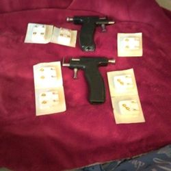 Ear Pearcing. Guns And Stud Earrings 