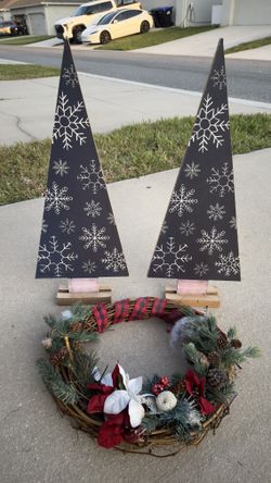 Selling 2 wooden trees with garland.