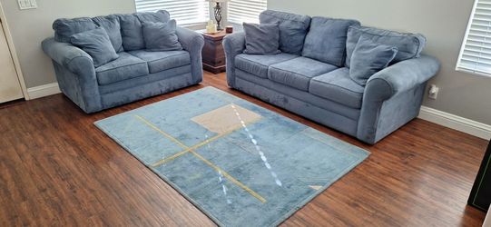 Sofa and love seat set with matching area rug