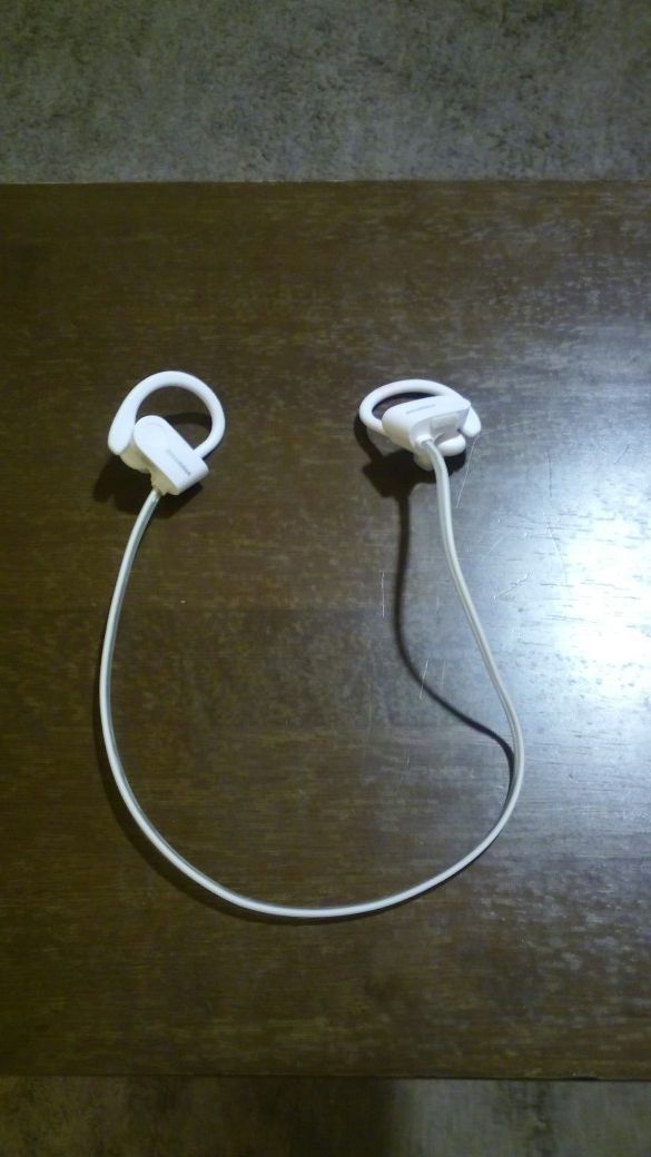 white bluetooth earhook headphones