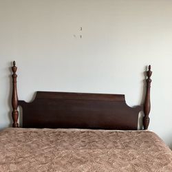 Mahogany four poster bed frame for a full-sized bed.