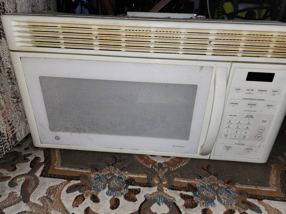 GE - Over the Range Microwave Oven with vent fans and light Range Hood built in