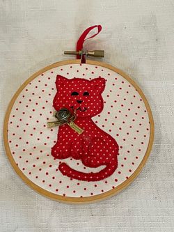 Handmade red cat fabric art piece framed in a wooden embroidery hoop. Ornament. 4.25”