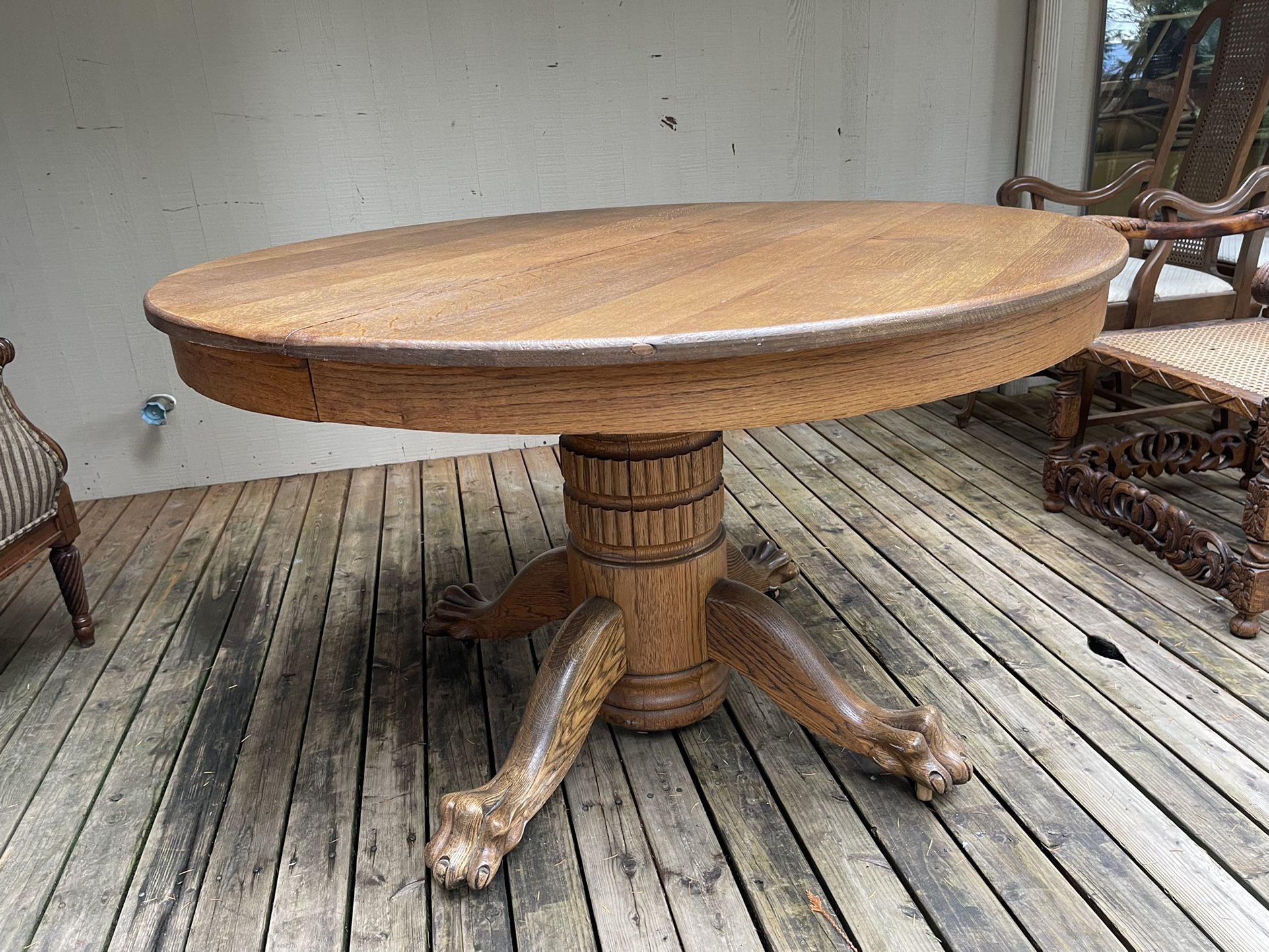 Beautiful antique clawfoot round dining table on casters. Solid real wood