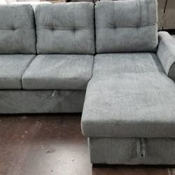Gray fabric sofa chaise sectional with a pullout bed