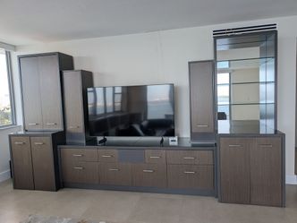 Gray wall unit with 2 wine fridges, 65" TV and stereo receiver with speakers