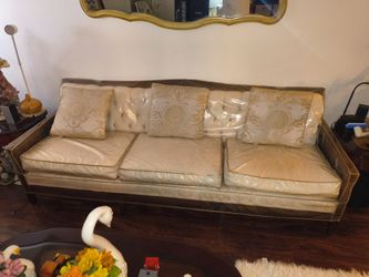 Antique sofa and 2 chairs with plastic covers and pillows
