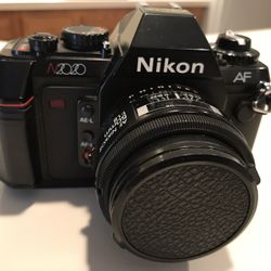 Nikon N2020 Camera, Nikkor 50 mm 1:1.8 lens and a flash