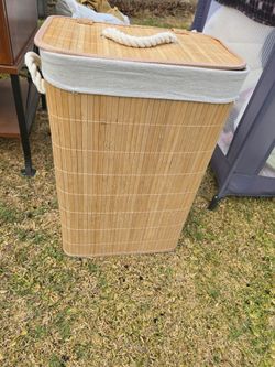 Rectangular bamboo laundry hamper with a lid,