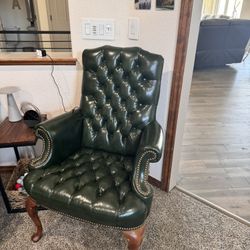 Leather and hardwood high wing back chairs with tufted button design.
