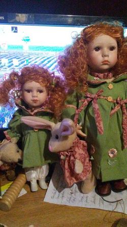 2 sister dolls with stuffed animals.