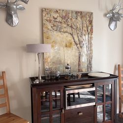 Dark wood buffet cabinet with glass doors