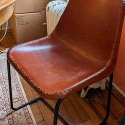 Two CB2 leather dining/accent chairs