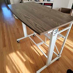 Adjustable craft table on wheels