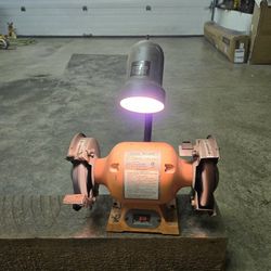 Central Machinery 6" Bench Grinder with flexible light, powers on when plugged in, no safety guards