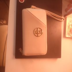 Badgley Mischka Rae collection wristlet wallet in a tan and white color scheme with a gold-tone logo. 