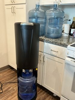 Water Dispensary With 4 Of The 5 Gallons