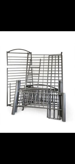 Silver metal twin-over-twin bunk bed frame with ladder and guardrails.