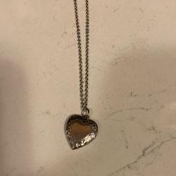 Silver color necklace with a heart