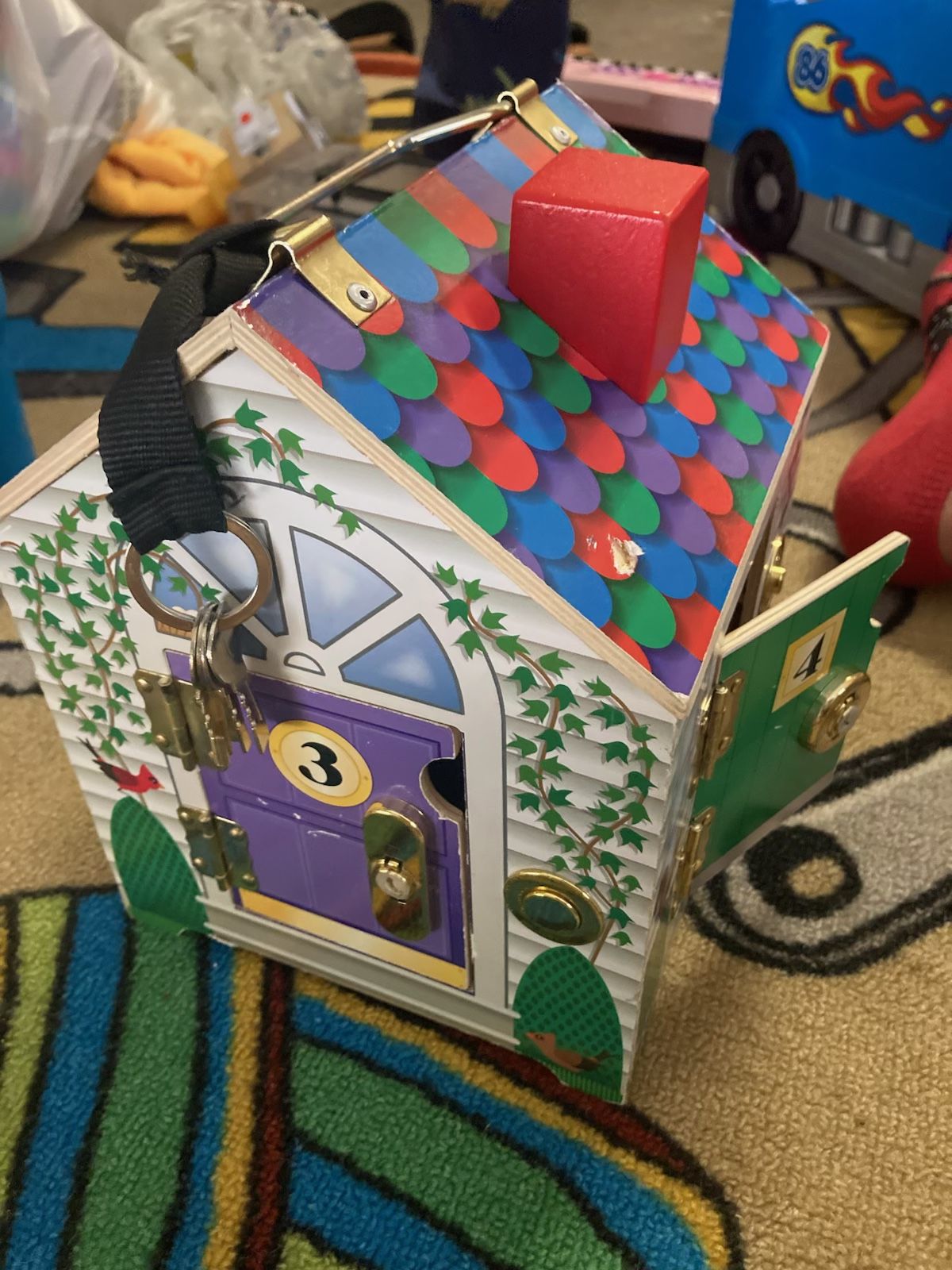 Barely used. Melissa & Doug wooden doorbell house with keys still attached. Small fabric figures not included. $20 OBO