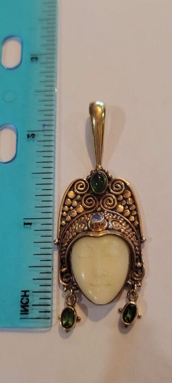 18k princess pendant Two Peridot on her earrings, one Chrome diopside on that bail and one tanzanite Stone on her forehead 17.5 G  $1500.00