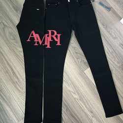 Amiri black/red staggered logo denim jeans