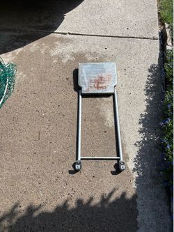 Material holder for extension ladder